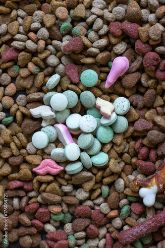 Vitamin tablets for pets on hip of dry pet food.