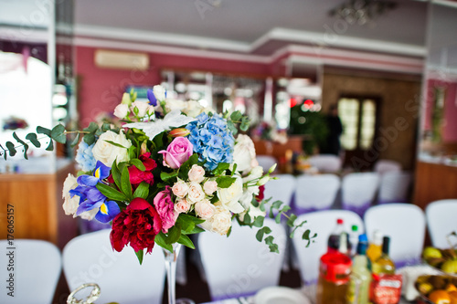 Floral compositions made of different flowers, decorated for the wedding celebration in the restaurant exclusively.