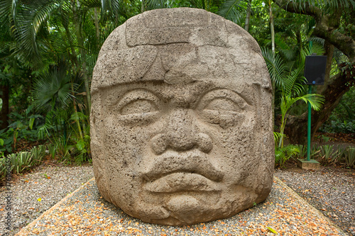 large pre-hispanic olmec basalt carved head in the La Venta archeological park in Villahermosa Mexico photo