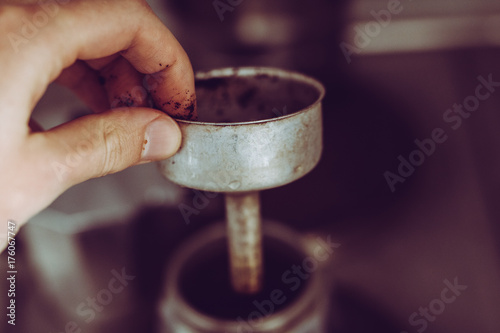 Making coffee with a percolator : steamy caffeine drink with hand making it photo