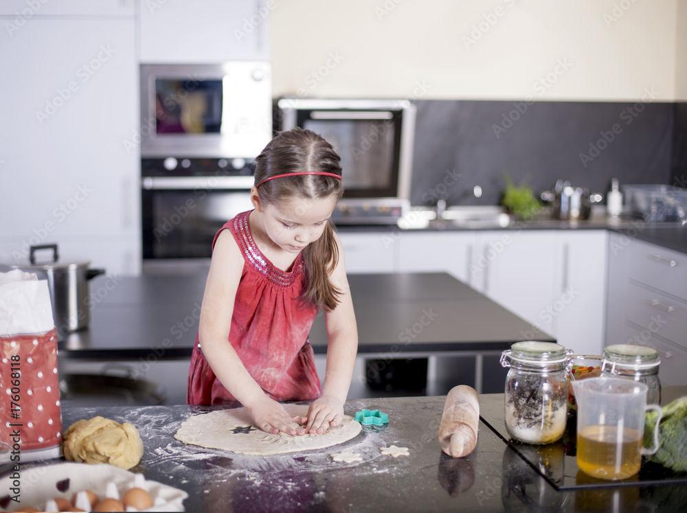 little cute girl is learning how to make cake, in kitchen, Family concept