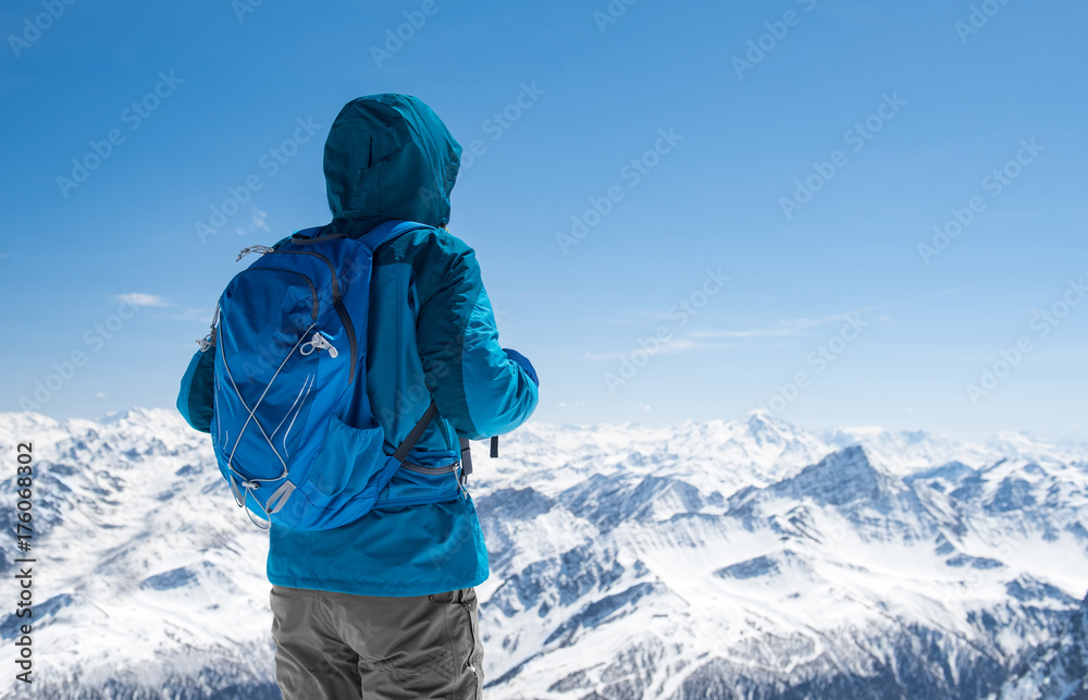 Hiker looking at snowy mountain