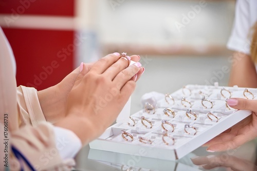Slika na platnu Cropped close up of a woman trying on an engagement ring at the jewelry store
