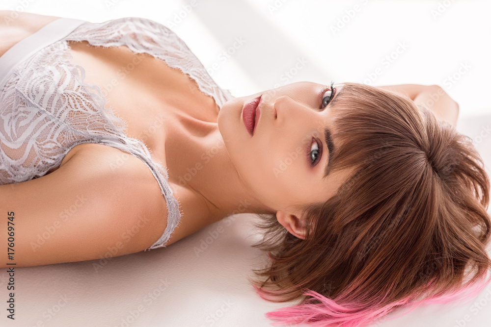 woman in lace bralette lying on floor woman in lace bralette lying on floor