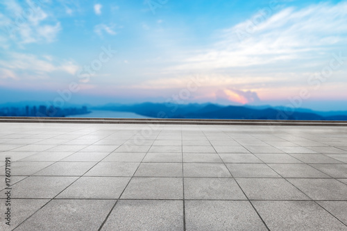 empty marble floor with modern city and long river