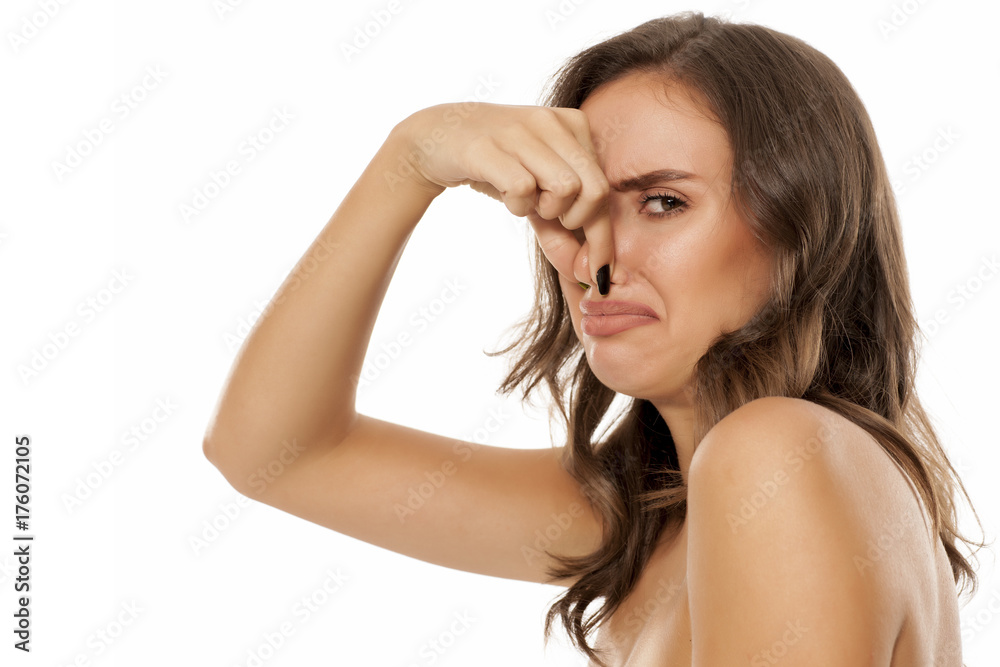 Portrait of beautiful young disgusted woman on white background Portrait of beautiful young disgusted woman on white background