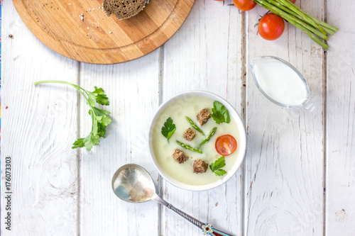 Top view of nice asparagus cream soup with toasted bread.