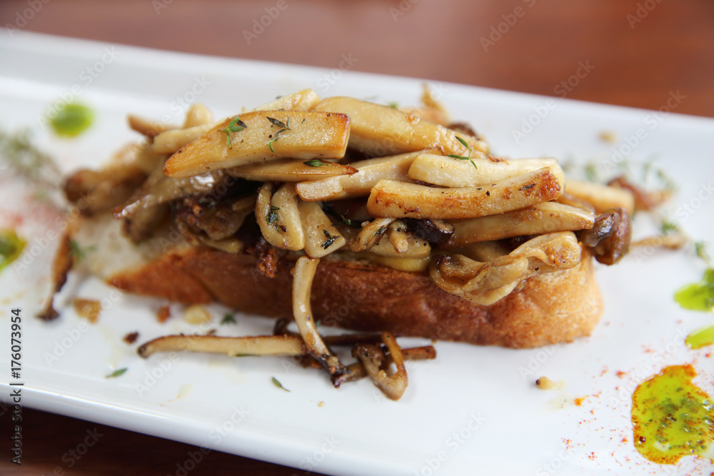 Crispy toasted white bread with mushrooms on wood background table Crispy toasted white bread with mushrooms on wood background table