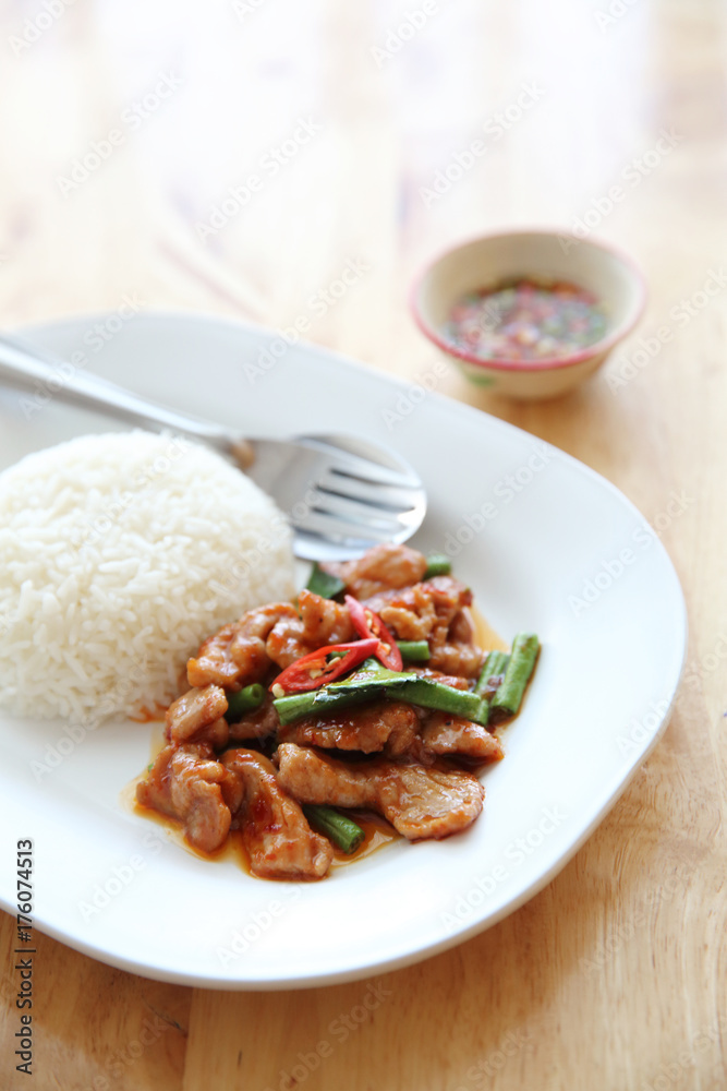 fried pork with thai curry and rice on wood background , Thai food fried pork with thai curry and rice on wood background , Thai food