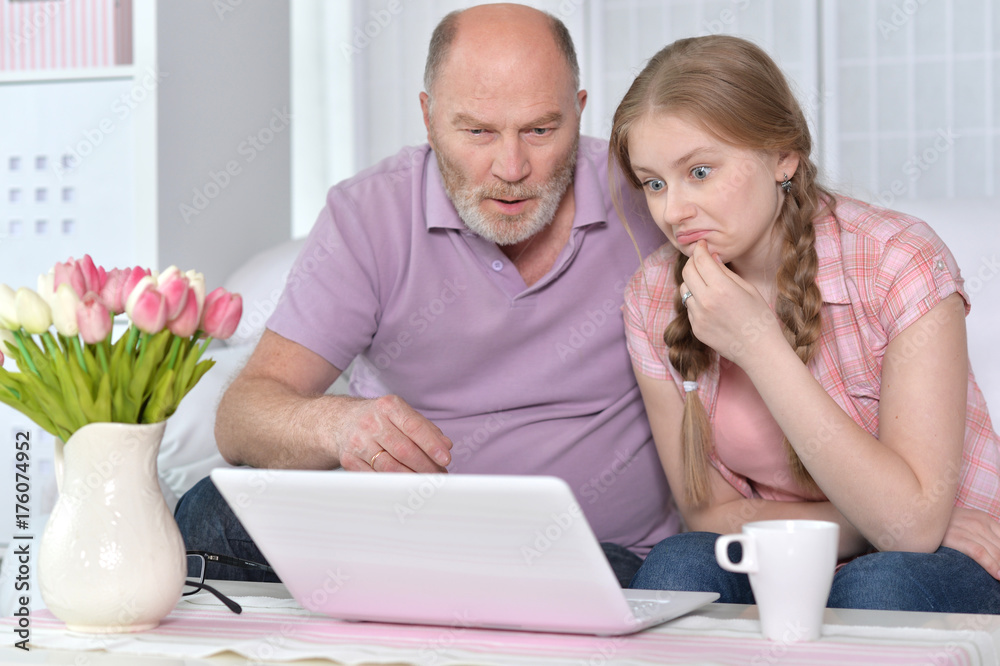 Grandfather and granddaughter using laptop Grandfather and granddaughter using laptop