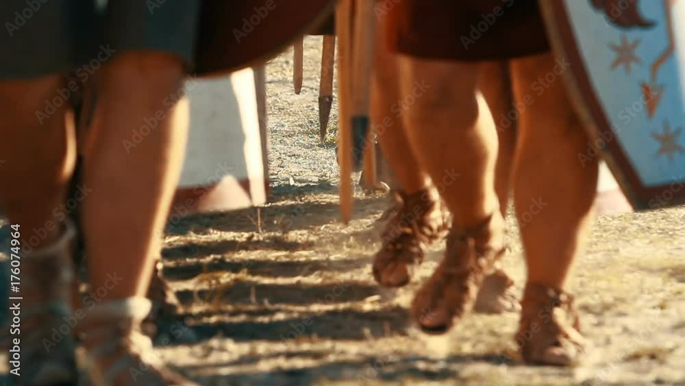 A soldiers marching in row with shields, spears and swords A soldiers marching in row with shields, spears and swords
