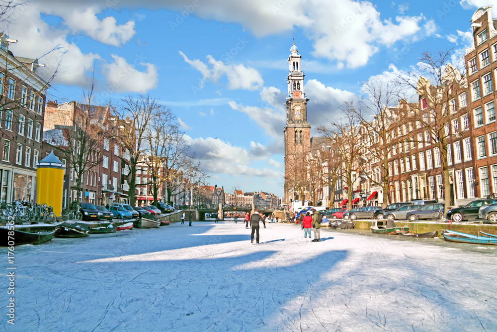 Naklejka premium Amsterdam in winter with the Westerkerk in the Netherlands