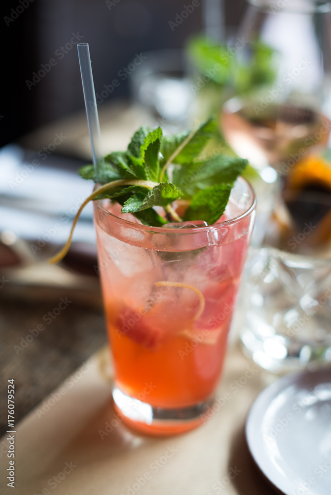 Cold ginger and grapefruit mojito cocktail with mint in icy highball glass for hot summer day, fresh aperitif on restaurant table Cold ginger and grapefruit mojito cocktail with mint in icy highball glass for hot summer day, fresh aperitif on restaurant table