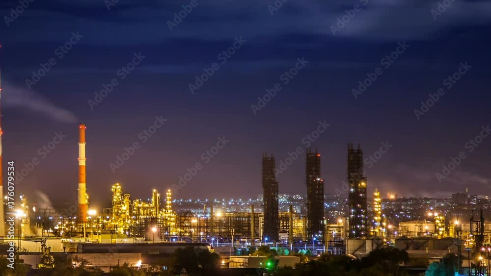 Oil refinery night timelapse with clouds in background. Gas industry background. Oil refinery night timelapse with clouds in background. Gas industry background.