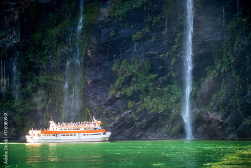 Scenic cruise approaches waterfall, Milford Sound.
