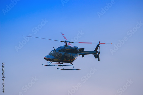 Helicopter flying in the blue sky