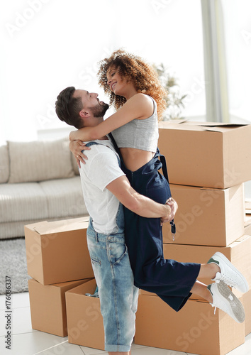Hugging couple, against the background of boxes