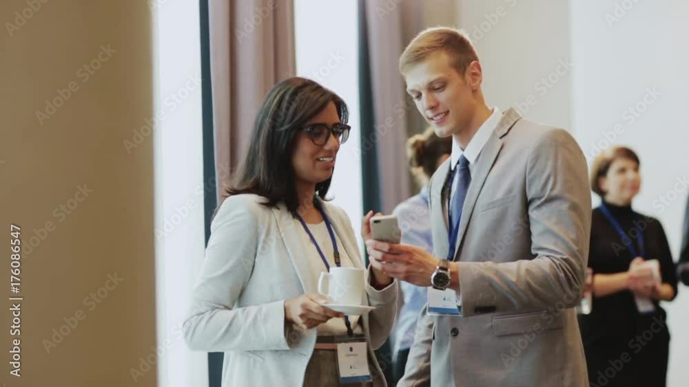 couple with smartphone at business conference couple with smartphone at business conference