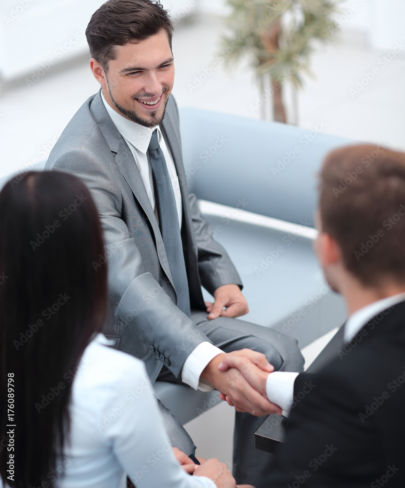 handshake business partners in the lobby of the office. handshake business partners in the lobby of the office.