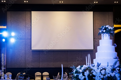 Front view of wedding room with empty white projector screen