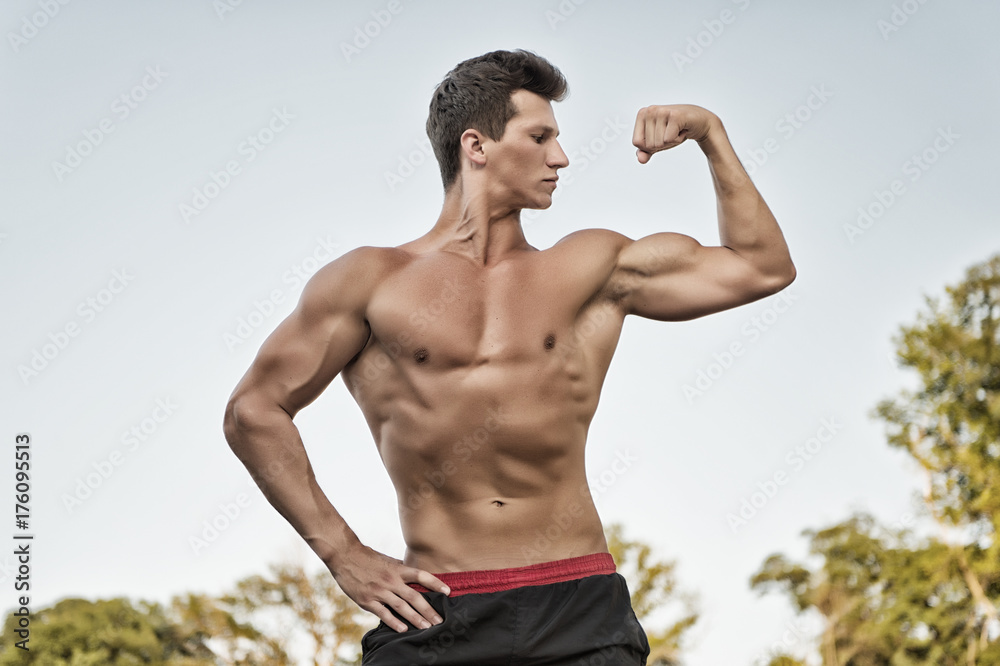 Bodybuilder showing muscles, biceps and triceps