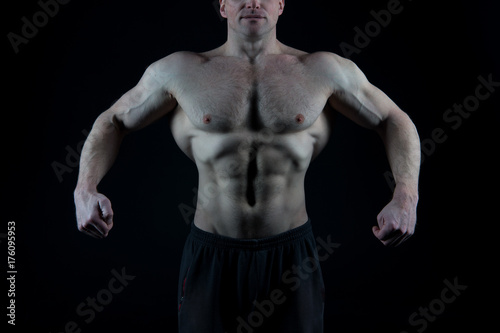 Man showing fit torso, abs, six pack, belly, chest, arms