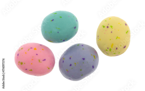 Top view of several speckled Easter egg malt ball candies isolated on a white background.