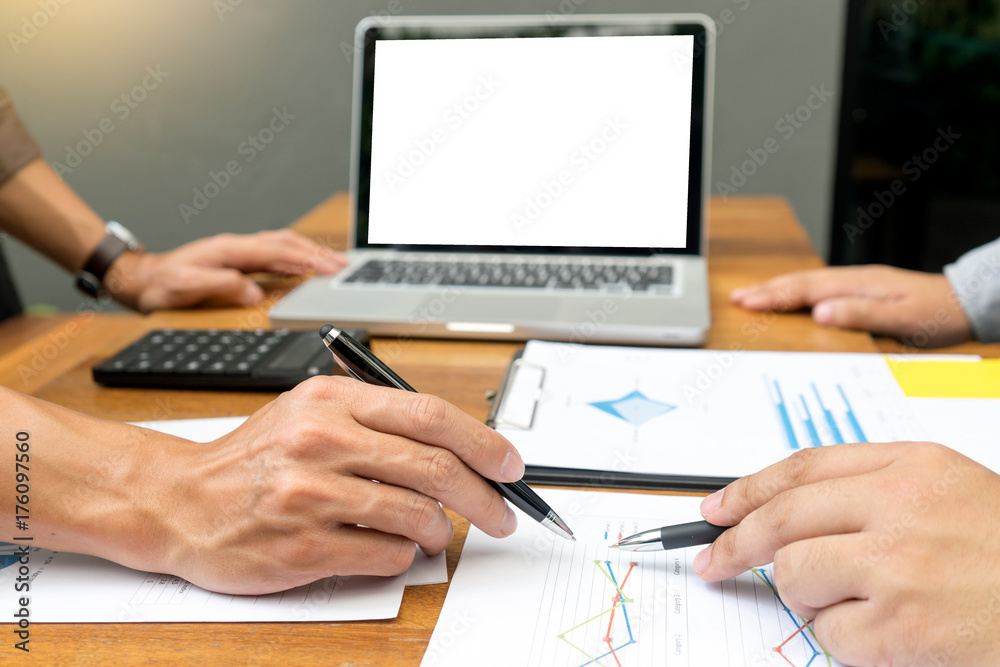 Businessman and staff working with computer on wood table with white computer Businessman and staff working with computer on wood table with white computer