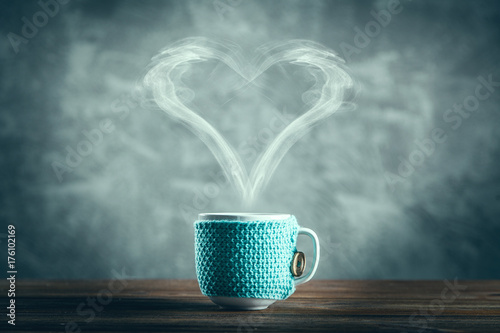 Cup of coffee with a heart shaped steam