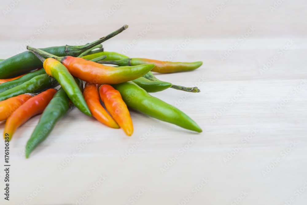 Hot Chilli Peppers isolated on wood board background, close up. Selective focus Hot Chilli Peppers isolated on wood board background, close up. Selective focus