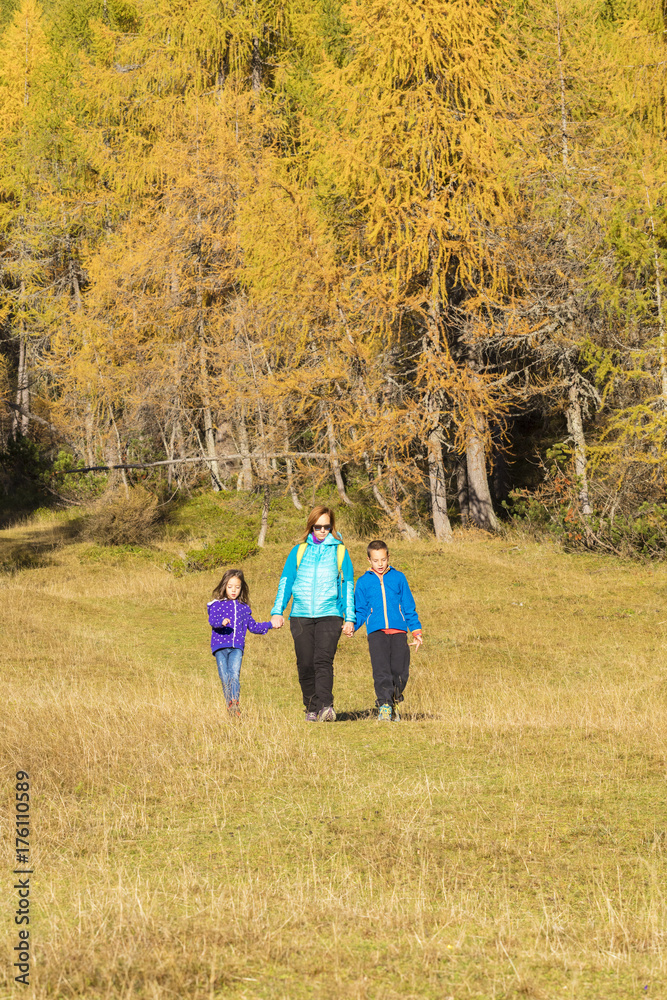 Active family spending time hiking in the colourful woods. Active family spending time hiking in the colourful woods.
