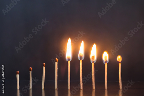 Abstract image with burning matches. Concept of different phases in human life from birth to old age