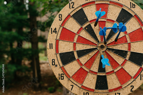 Darts in a dartboard outdoors