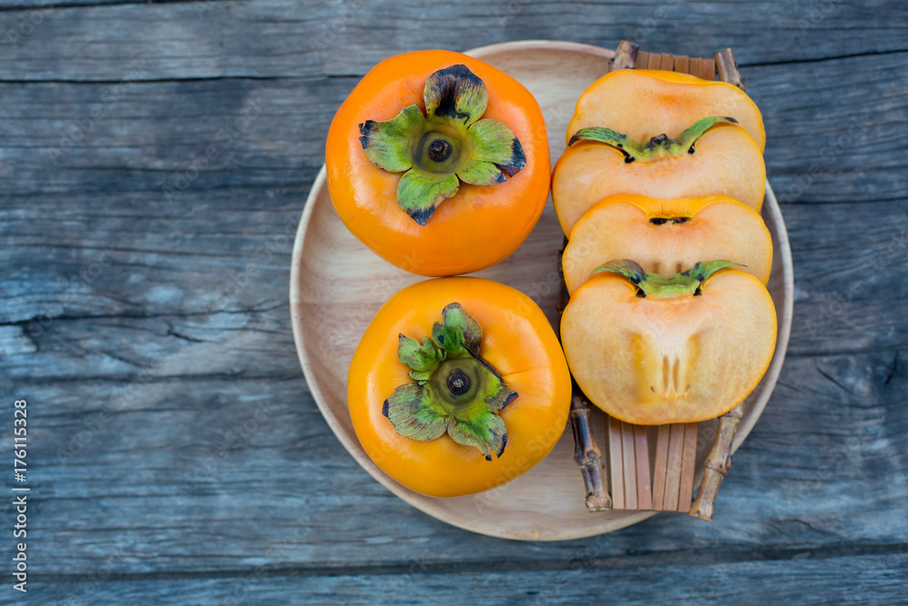 ripe persimmon on wooden background