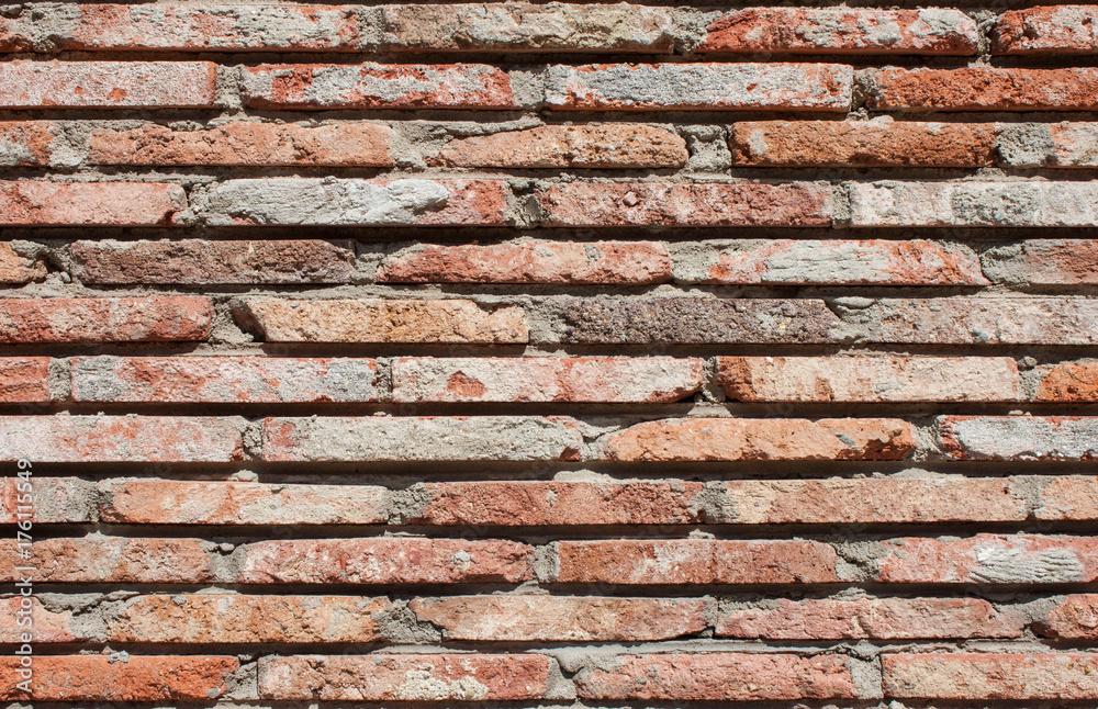 Old wall of red briks tiled background, regular block texture. Wallpaper of ordinary building. Background