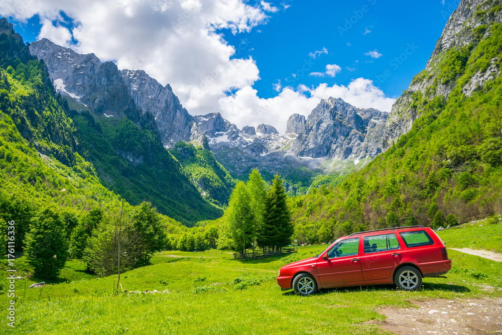 MONTENEGRO, PROKLETIJE MOUNTAINS - MAY 29/2017: tourists in car went on a trip to the snow-capped mountains. MONTENEGRO, PROKLETIJE MOUNTAINS - MAY 29/2017: tourists in car went on a trip to the snow-capped mountains.