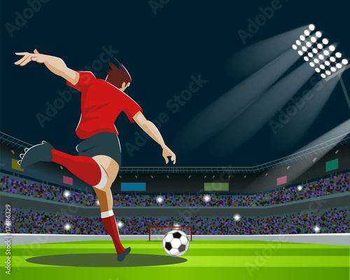 Soccer Player Kicking Ball in stadium. Light, stands, fans.