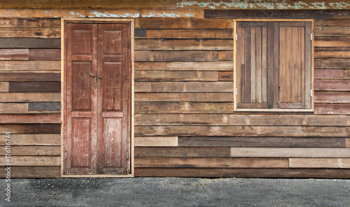 Traditional double wooden doors and window on the old wood wall for background and texture.