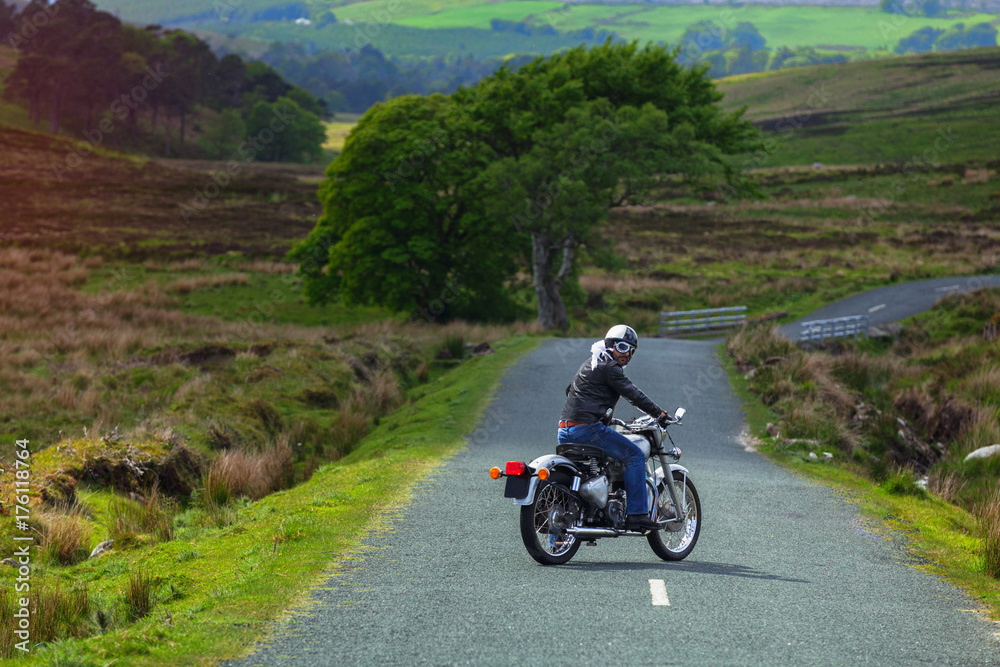 Biker looks back before heading off on a motorcycle Biker looks back before heading off on a motorcycle