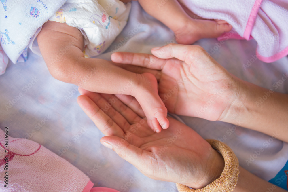 small feet of baby carry by mom hands small feet of baby carry by mom hands