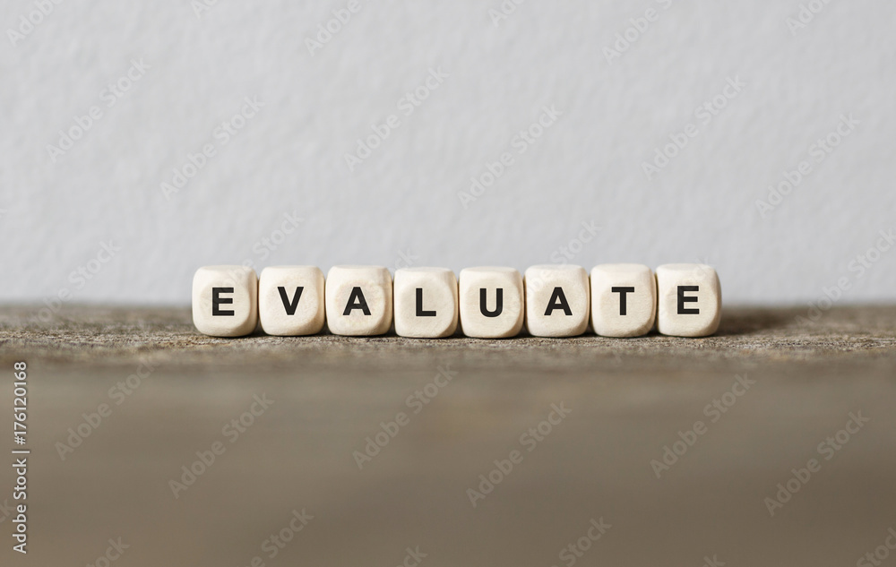 Fotografie Word EVALUATE made with wood building blocks