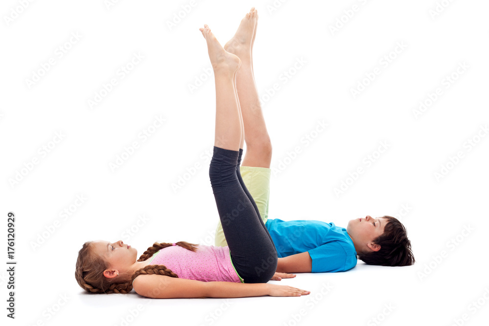 Kids doing gymnastic exercises on the floor