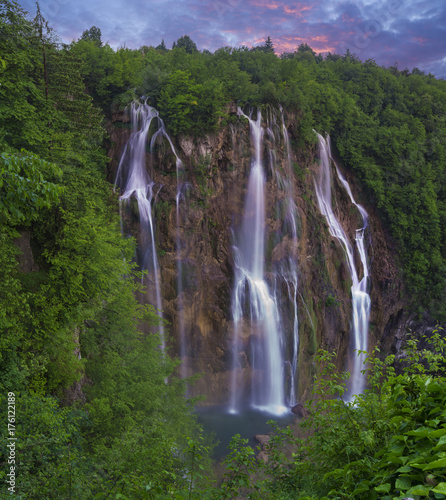 foggy and multicolored dawn over beautiful waterfalls in the park of plitvice lakes in croatia