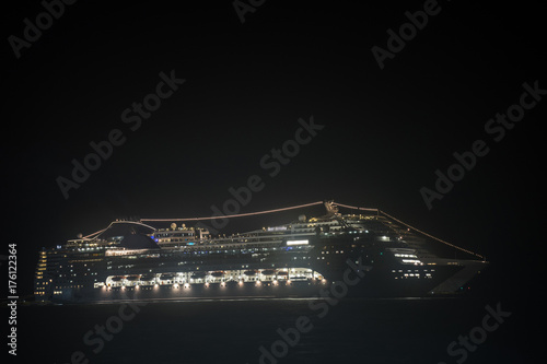 Photo A huge cruise ship at night stands at anchor glowing with very bright lights