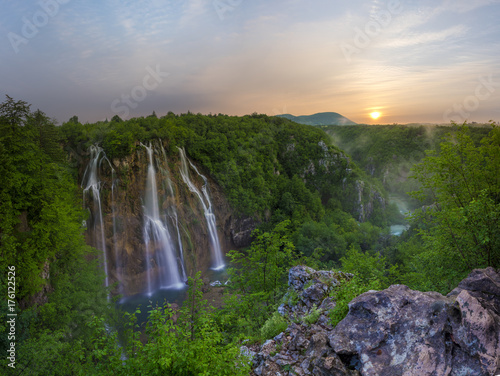 Fototapeta Naklejka Na Ścianę i Meble -  foggy and multicolored dawn over beautiful waterfalls in the park of plitvice lakes in croatia