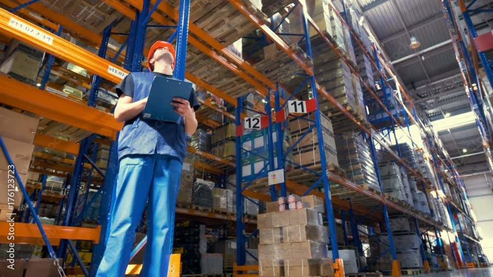 A low view on a warehouse inspector at work. A low view on a warehouse inspector at work.