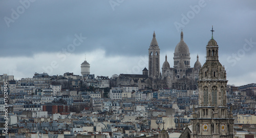 Skyline View of Monmartre, Paris in France with dark Clouds