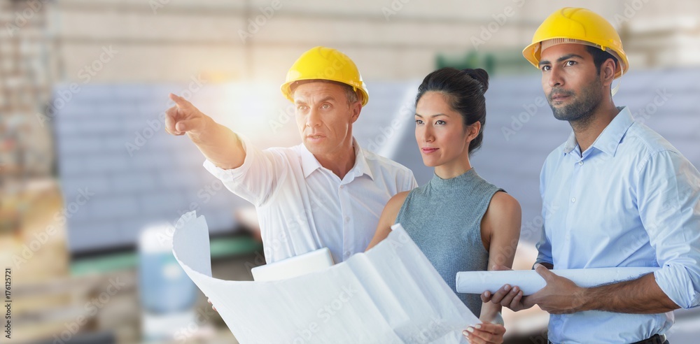 Composite image of architects looking away while holding Composite image of architects looking away while holding