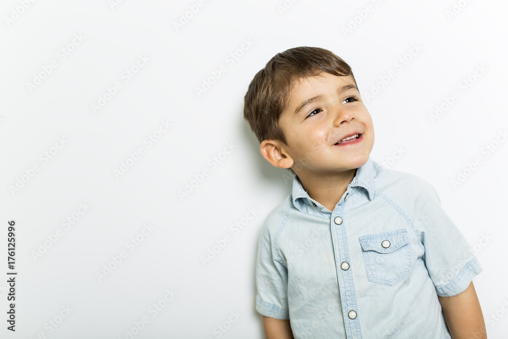Boy having fun on studio grey background Boy having fun on studio grey background