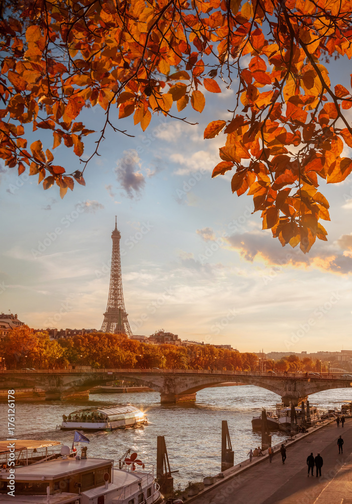 Paris with Eiffel Tower against autumn leaves in France